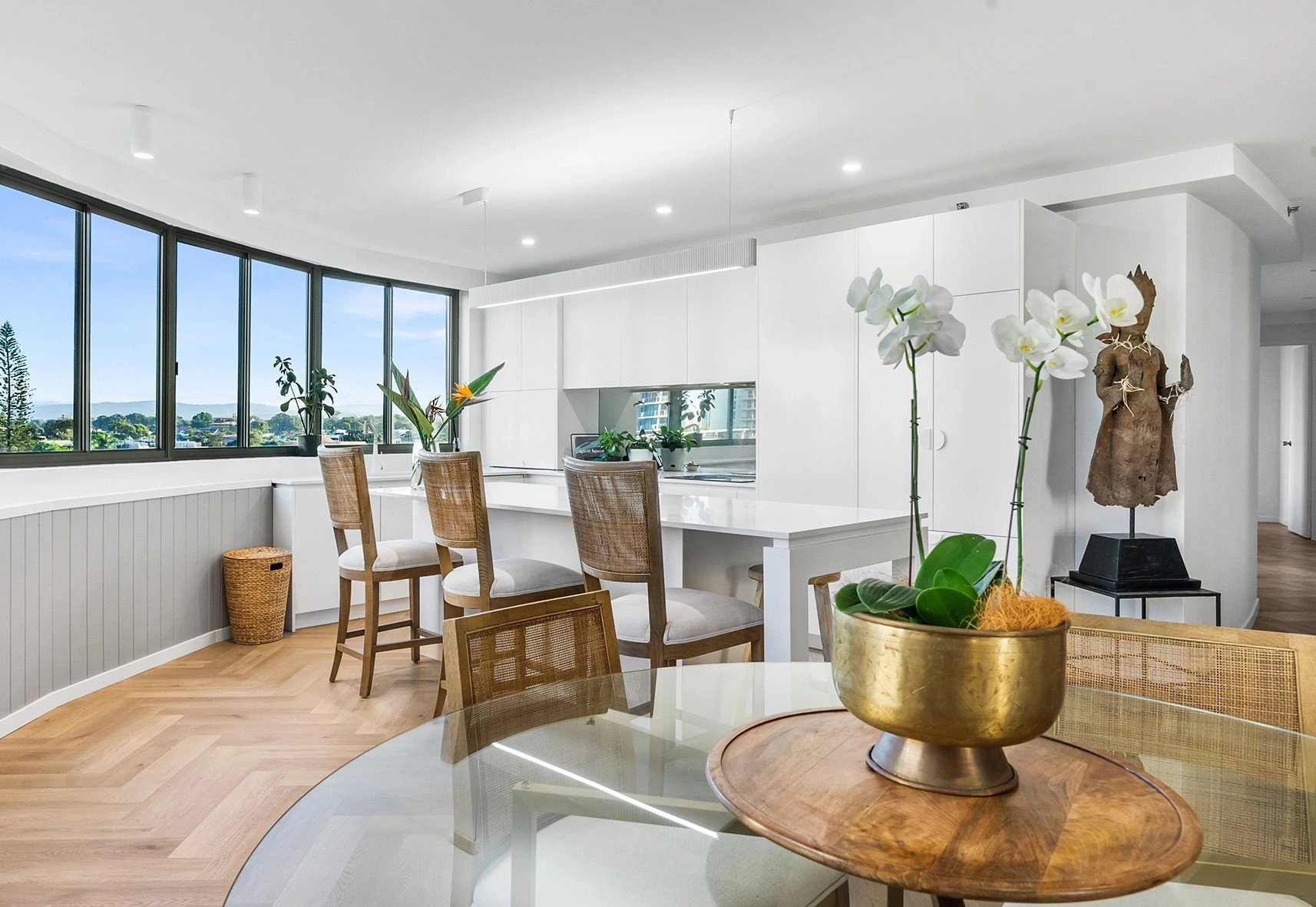 Elegant modern interior featuring open-plan living space with ocean views, contemporary furnishings, and Main Beach Design aesthetic